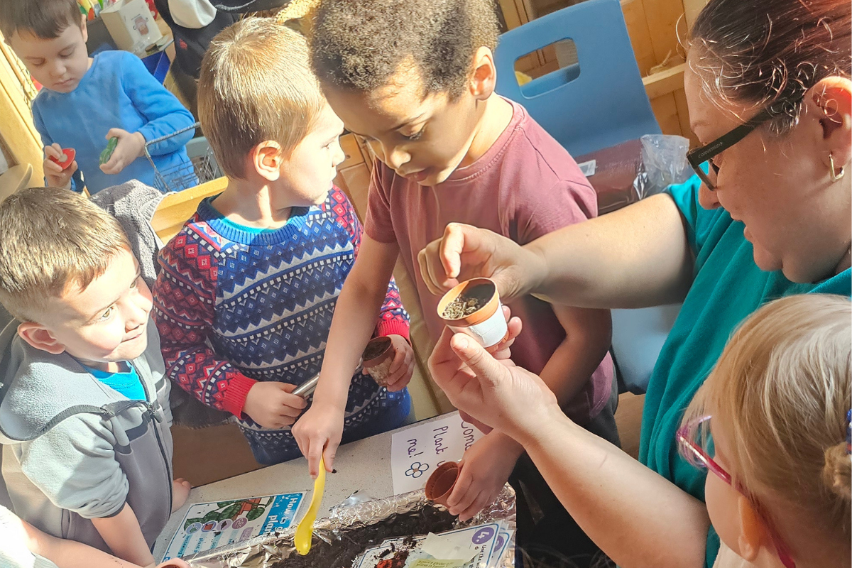 Children taking part in an outdoor learning activity at Nurtured @ Balby nursery