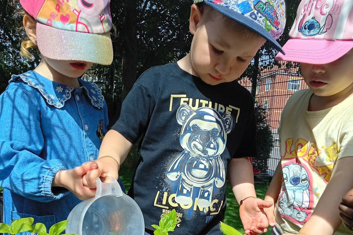 Children enjoying outdoor sensory play at Nurtured @ Balby nursery